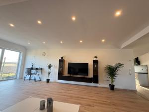 a living room with a large flat screen tv on a wall at Ferienwohnung Waldblick Alterkülz in Alterkülz