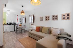 a living room with a couch and a kitchen at Casa Do Alto in Tavira