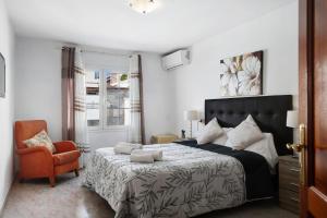 a bedroom with a bed and a chair at Villa Muñoz in Puerto del Carmen +23 photos
