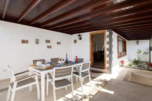 a dining room with a table and chairs at Villa Muñoz in Puerto del Carmen
