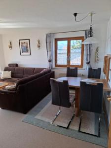 a living room with a couch and a table at Ferienwohnung Leni in Sonthofen