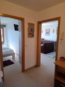 a living room with two doors and a couch at Ferienwohnung Leni in Sonthofen