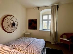 a bedroom with a bed and a window and a fan at Vorwerk Biensdorf in Lichtenau