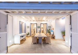 a dining room with a table and chairs at Blueros - Olive suite in Megas Gialos - Nites