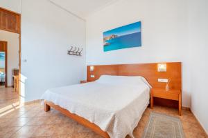 a bedroom with a large bed and a wooden headboard at Ses Comes de Son Cladera in Manacor +17 photos