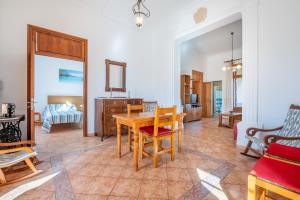 a living room with a wooden table and chairs at Ses Comes de Son Cladera in Manacor
