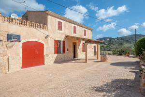 a building with a red door on a street at Ses Comes de Son Cladera in Manacor
