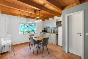 a kitchen with a table and chairs in a room at Ferienwohnung am Hirschfelsen in Bühlertal +19 photos