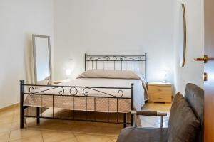 a bedroom with a bed with a mirror and a couch at Acqua in Follonica