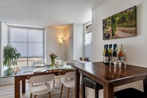 a dining room with a table with chairs and wine bottles at Ferienwohnung Zur Weinsteige in Ihringen