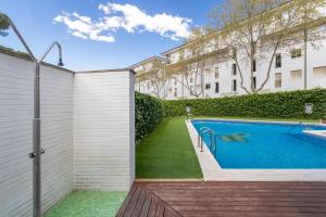 a swimming pool in a yard next to a building at Mar i Llum in Platja d'Aro