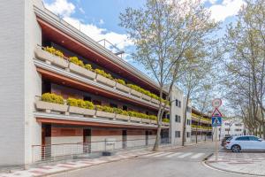 a building with flowerpots on the balconies on a street at Mar i Llum in Platja d'Aro