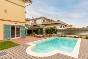 a swimming pool in the backyard of a house at Relax in Villa - Versilia in Massa