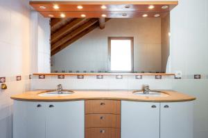 a bathroom with two sinks and a large mirror at Chalet au bois joli in Valloire +30 photos