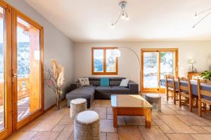 a living room with a couch and a table at Chalet au bois joli in Valloire