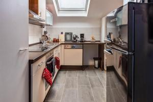 a small kitchen with a refrigerator and a sink at Radolfzell Bodensee in Radolfzell am Bodensee