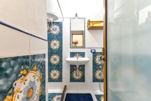 a bathroom with a sink and a mirror at Casa Vacanze Iosè in Rio Marina +16 photos