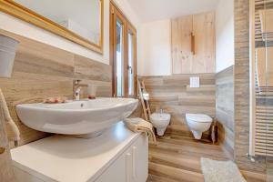 a bathroom with a white sink and a toilet at Cascina Nonna Nina in Credaro +25 photos