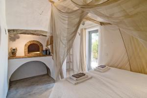 a bedroom with a bed with a canopy and a window at Casa Osga in Moncarapacho
