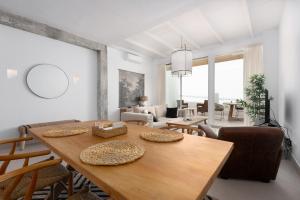 a living room with a wooden table and chairs at Vivienda Casares in Estepona