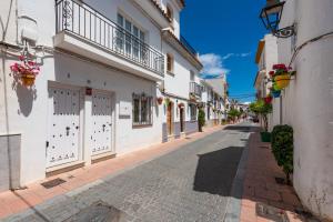 an empty street in a town with white buildings at Vivienda Casares in Estepona