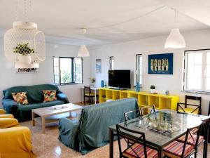 a living room with a couch and a table at Casa Lagoa Mar in Costa de Santo André