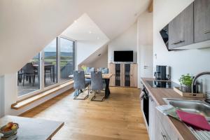 a kitchen and dining room with a view of a dining table at Blick zum Säntis in Horgenzell
