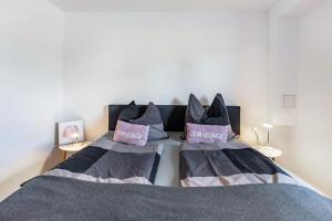 a bedroom with a bed with two pillows on it at Schmuckstückchen in Hilzingen