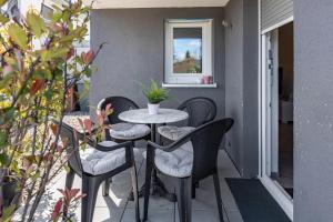 a small table and chairs on a balcony at Schmuckstückchen in Hilzingen +16 photos