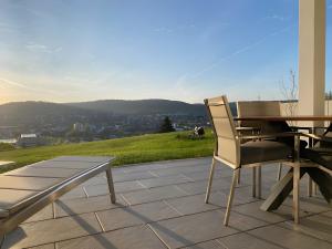 a table and chairs sitting on a patio with a view at Ferienwohnung Panoramablick in Lörrach