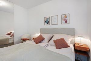 a bedroom with a white bed with two pillows at Ferienwohnung Panoramablick in Lörrach