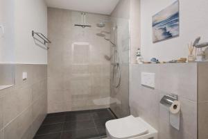 a bathroom with a shower and a toilet at Ferienwohnung Panoramablick in Lörrach +19 photos
