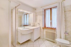 a bathroom with a sink and a toilet and a mirror at A Due Passi Valdidentro in Valdidentro +29 photos