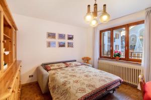 a bedroom with a bed and a window at A Due Passi Valdidentro in Valdidentro
