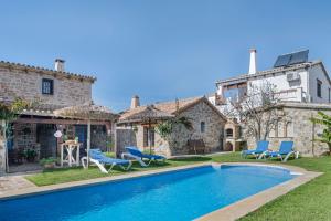a villa with a swimming pool in front of a house at Casas Alfonso y Laura in Conil de la Frontera