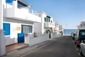 a street in positano with the ocean in the background at La Chinija in Playa Honda