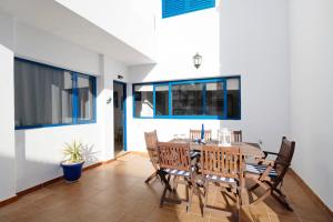 a dining room with a table and chairs at La Chinija in Playa Honda