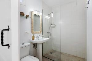 a bathroom with a sink and a toilet and a mirror at La Chinija in Playa Honda +21 photos