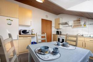 a kitchen with a table with two cups on it at Ferienwohnung Tannhausen in Aulendorf