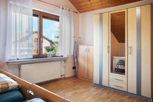 a living room with a window and a door at Ferienwohnung Tannhausen in Aulendorf +16 photos