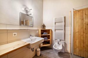 a bathroom with a sink and a toilet at Grushof App Paföl in Sluderno