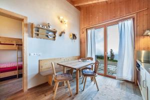 a kitchen and dining room with a table and chairs at Grushof App Paföl in Sluderno +13 photos