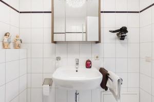 a white bathroom with a sink and a mirror at Schweizer Grenze in Waldshut-Tiengen +12 photos