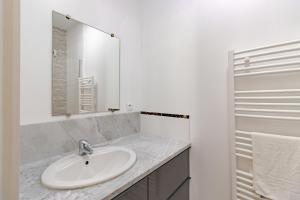 a white bathroom with a sink and a mirror at Le Promontoire in Groléjac +26 photos