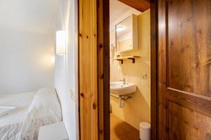a small bathroom with a sink and a bed at Agriturismo Les Ecureuils in Saint-Pierre +68 photos