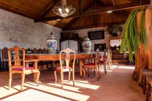 a dining room with a large wooden table and chairs at W430 Guimarães in Guimarães