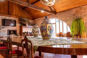a dining room with a table with two vases on it at W430 Guimarães in Guimarães