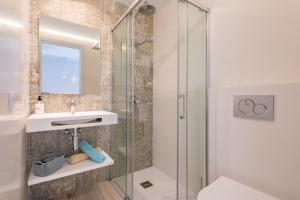 a bathroom with a glass shower and a sink at Apartamento Ola de Mar in Felanitx +17 photos
