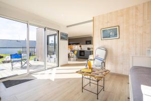 a living room with a view of the ocean at La Cabane in Combrit