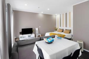 a living room with a white table and a couch at 58 Studio in Ribeira Grande